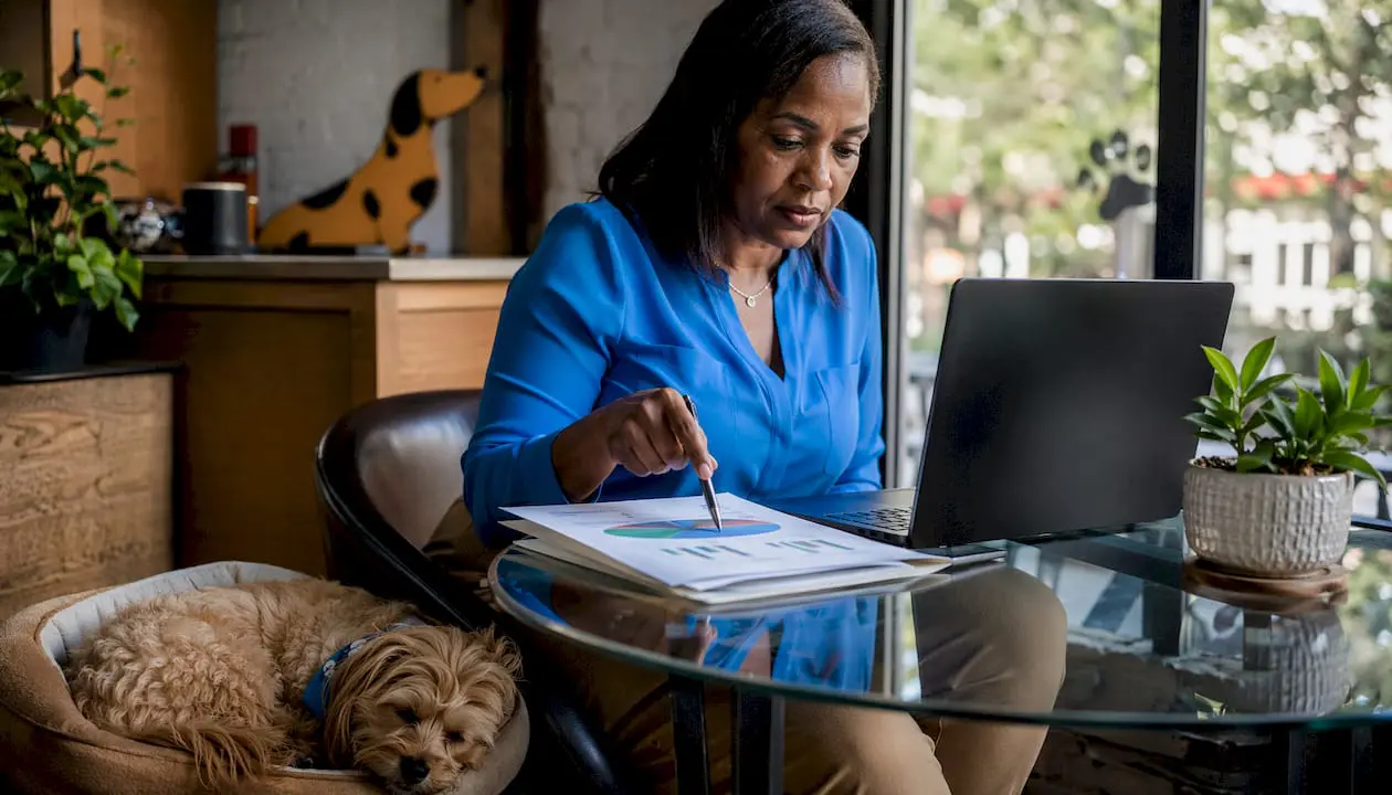 Woman reviewing U.S. pet market reports at desk
