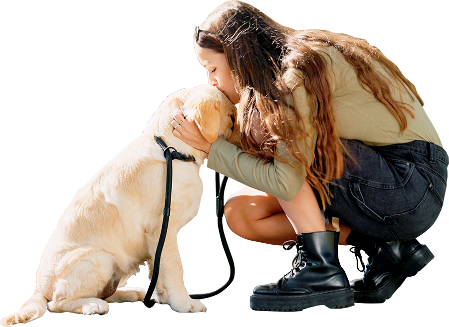 Woman kissing dog on the head during training session