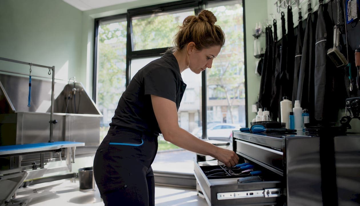 Pet groomer preparing grooming tools indoors