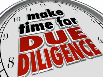 A clock with the phrase, "Make time for due diligence," written on it in black and red letters.