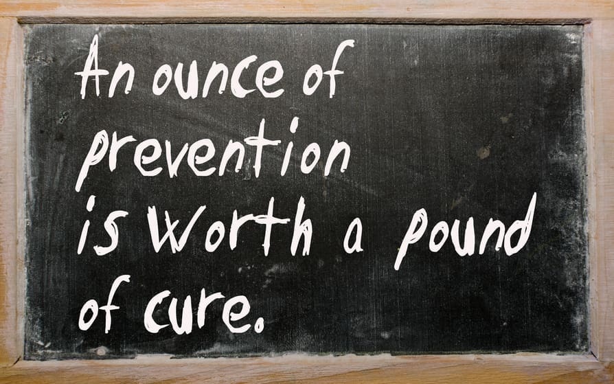 Blackboard with the text "An ounce of prevention is worth a pound of cure."