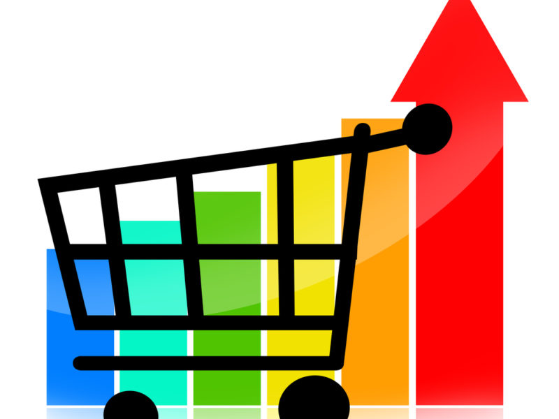 A black shopping cart in front of a multicolored bar chart.