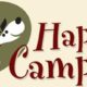 A beige, green, and red banner with a cartoon dog wagging its tail that reads, "Happy Camper."